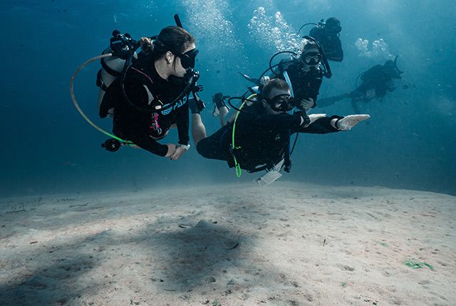 Woman Trying Scuba Diving in Utila, Honduras.